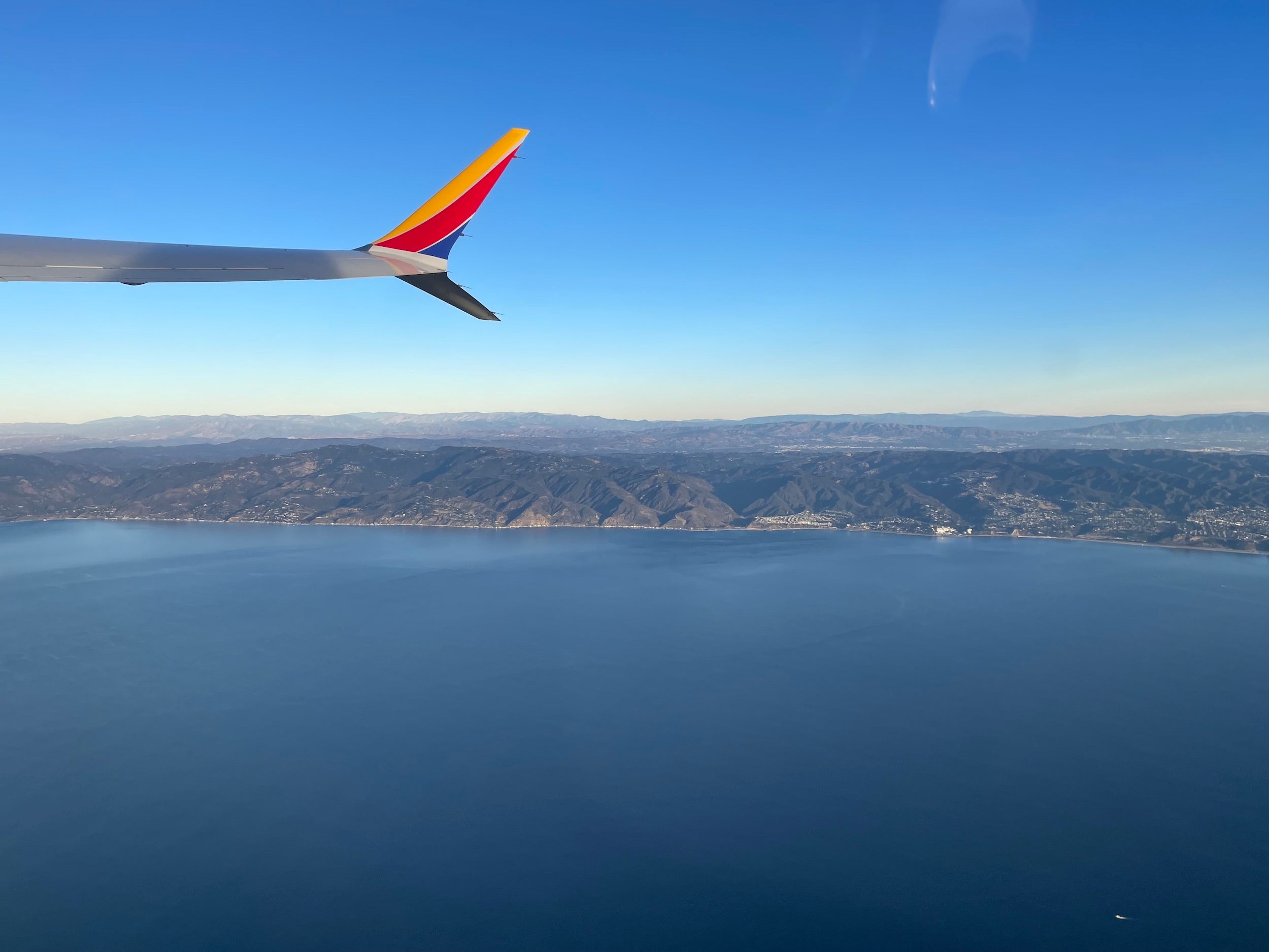 A view from an airplane window representing the ultra-low humidity environments where the Samson California Altitude Protocol protects the skin barrier.