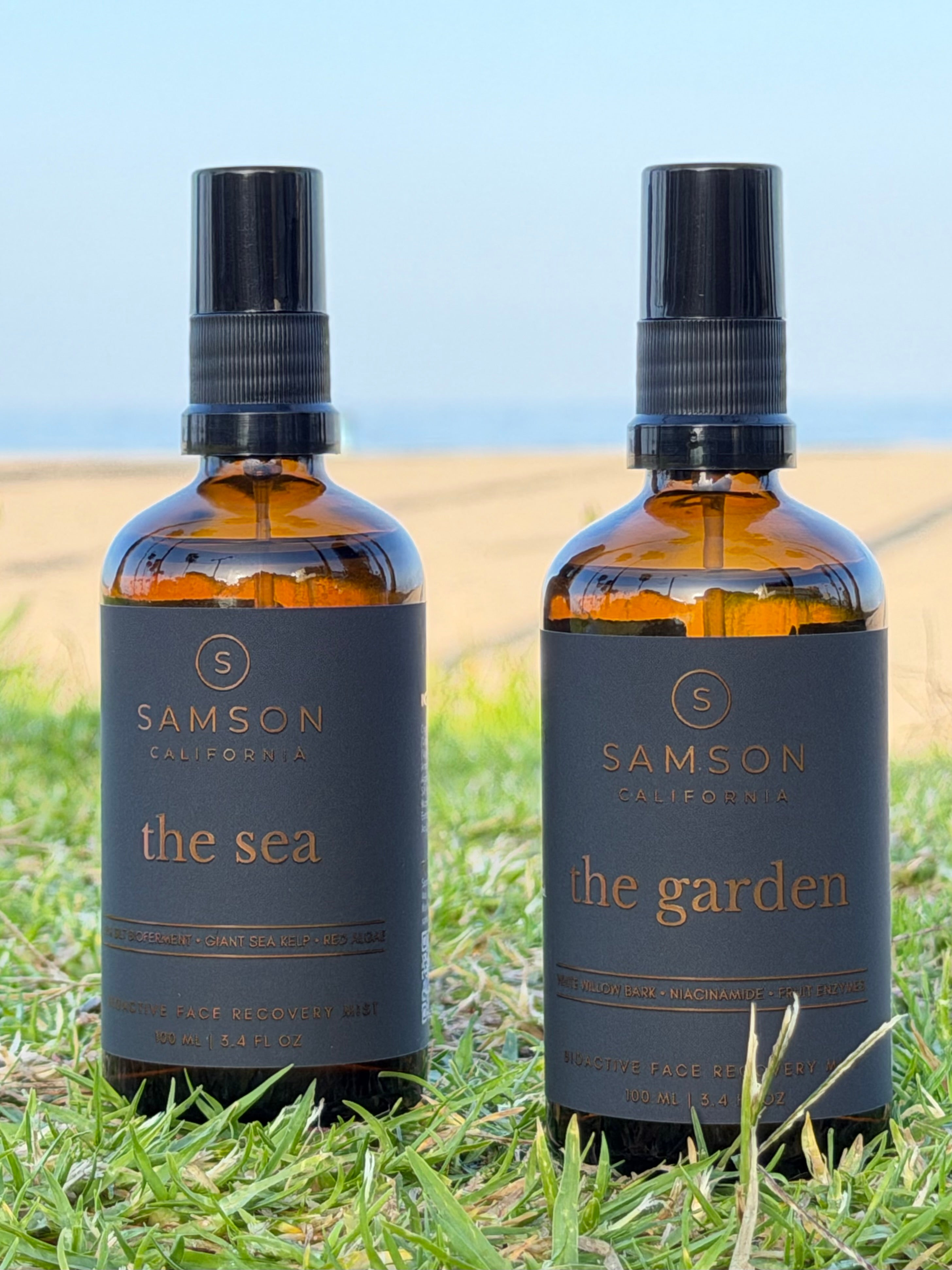 Samson California Dual Phase Protocol featuring The Sea and The Garden Bioactive Face Recovery Sprays in premium amber glass bottles with fine mist sprayers on a California beach